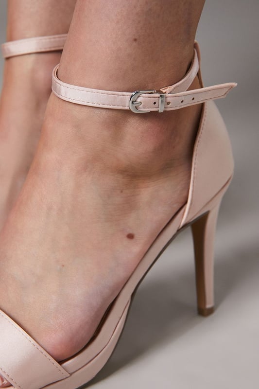 Elegant faux leather heeled sandals with a platform sole
Ankle strap with metallic buckle fastening for a secure fit
Open toe design to elongate the leg
Towering stiletto heel height of 7-9cm
Metallic finish exudes sophistication and glamour

Crafted with meticulous attention to detail, these Talia Platform Heeled Sandals from Coast are the epitome of refined elegance. Designed to make a statement at formal occasions like weddings, races, or graduations, these sandals radiate luxury. Style them with a floor-length gown or a tailored midi dress for a polished and sophisticated look that commands attention. Embrace the allure of these sandals and let them be the centerpiece of your ensemble, elevating your confidence and poise for an unforgettable evening.