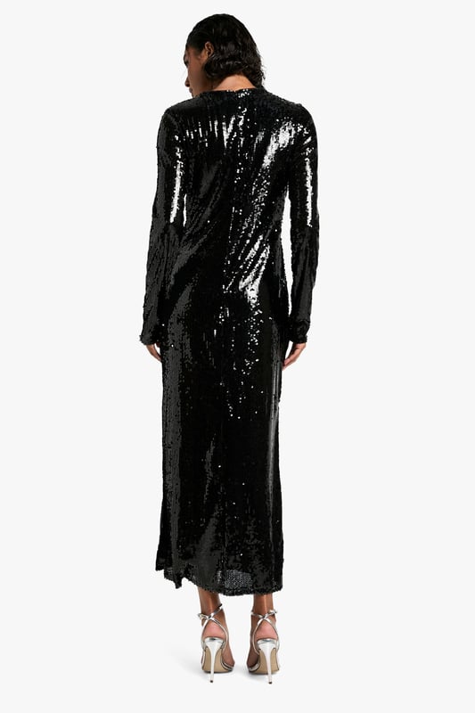 All-over sequin embellishment for maximum sparkle
        Flattering maxi length with side slit for ease of movement
        Long sleeves and crew neckline for a sophisticated silhouette
        Figure-hugging design accentuates curves
        Versatile style suitable for various festive occasions
    
    Make a dazzling entrance at your next Christmas soire with this show-stopping sequin maxi dress. The all-over embellishment catches the light beautifully, ensuring you'll be the centre of attention. Its figure-hugging silhouette and maxi length create an elegant, elongated look, while the side slit adds a touch of allure and allows for graceful movement. Perfect for festive celebrations, pair it with strappy metallic heels and a sparkly clutch for a glamorous ensemble. For a more understated look, layer with a faux fur stole and opt for minimal jewellery to let the dress do the talking. Whether you're attending a Christmas party or planning your Christmas Day outfit, this versatile piece will have you looking and feeling fabulous throughout the festive season.