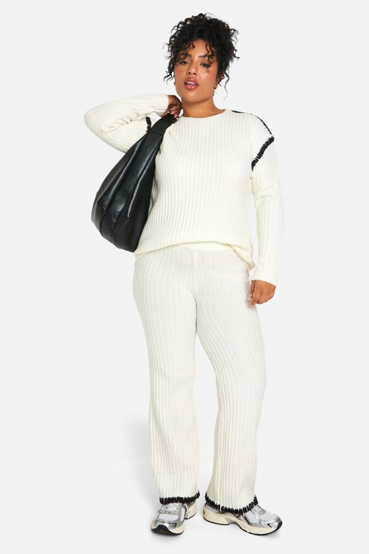 Cosy ribbed knit co-ord set for ultimate comfort
        Contrast trim detail adds a stylish edge
        Relaxed fit pullover with crew neckline
        Wide-leg trousers for a trendy silhouette
        Versatile two-piece ensemble for mix-and-match styling
    
    Embrace laid-back chic with this Plus Premium Pullover and Trouser set from Boohoo. The ribbed knit texture offers a tactile appeal while ensuring warmth and comfort for those casual days out. The contrast trim detail elevates the look, adding a contemporary twist to this cosy ensemble. Perfect for lounging at home or running errands, this co-ord set can be easily dressed up or down. Pair the pullover with your favourite jeans for a quick coffee run, or team the wide-leg trousers with a crisp white tee and trainers for a relaxed weekend look. For a complete outfit, throw on some statement earrings and a crossbody bag. This versatile set is a must-have for the fashion-forward woman who values both style and comfort in her everyday wardrobe.
