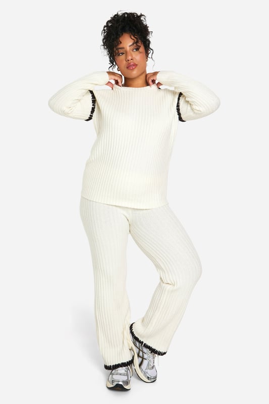 Cosy ribbed knit co-ord set for ultimate comfort
        Contrast trim detail adds a stylish edge
        Relaxed fit pullover with crew neckline
        Wide-leg trousers for a trendy silhouette
        Versatile two-piece ensemble for mix-and-match styling
    
    Embrace laid-back chic with this Plus Premium Pullover and Trouser set from Boohoo. The ribbed knit texture offers a tactile appeal while ensuring warmth and comfort for those casual days out. The contrast trim detail elevates the look, adding a contemporary twist to this cosy ensemble. Perfect for lounging at home or running errands, this co-ord set can be easily dressed up or down. Pair the pullover with your favourite jeans for a quick coffee run, or team the wide-leg trousers with a crisp white tee and trainers for a relaxed weekend look. For a complete outfit, throw on some statement earrings and a crossbody bag. This versatile set is a must-have for the fashion-forward woman who values both style and comfort in her everyday wardrobe.