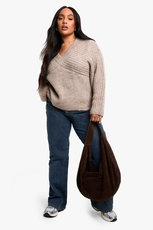 Ribbed texture for added visual interest
        V-neckline for a flattering silhouette
        Wide sleeves for a relaxed, comfortable fit
        Cropped length perfect for layering
        Versatile design suitable for various casual occasions
    
    Embrace comfort and style with this plus-size ribbed V-neck jumper. The wide sleeves offer a trendy, relaxed look while the cropped length adds a contemporary touch to your wardrobe. Perfect for those laid-back days, this jumper can be easily styled for various casual events. Pair it with high-waisted jeans and trainers for a quick coffee run, or dress it up with wide-leg trousers and statement earrings for a family gathering. The ribbed texture adds depth to your outfit, making it an ideal choice for transitional weather. Whether you're lounging at home or meeting friends for a casual lunch, this jumper provides the perfect blend of cosiness and chic appeal. Its versatility allows for effortless styling, making it a must-have addition to your everyday wardrobe.