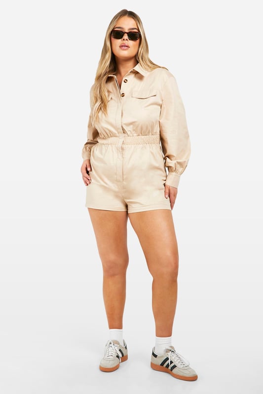 Long-sleeved utility playsuit with collar
        Elasticated waist for a flattering silhouette
        Functional chest pockets for added style and practicality
        Button-up front closure for easy wear
        Relaxed fit shorts for comfort and movement
    
    This versatile utility playsuit is the perfect addition to your going-out wardrobe. The long sleeves and collared neckline add a touch of sophistication, while the elasticated waist creates a flattering shape. Style it with trainers and oversized sunglasses for a cool daytime look, or dress it up with heeled sandals and statement jewellery for a night out with friends. The relaxed fit shorts ensure comfort for dancing the night away, while the functional chest pockets add a practical edge to this trendy piece. Whether you're heading to a bar for drinks or meeting new people at a club, this playsuit will have you looking effortlessly chic and ready for any urban adventure.