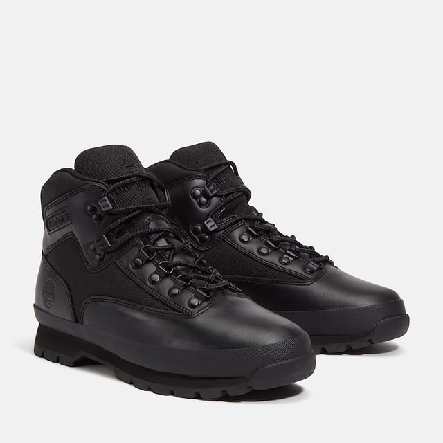 Hiking boots crafted with premium Timberland® leather and canvas upper, cushioned EVA footbed, and ReBOTL™ fabric lining made from at least 50% recycled PET plastic. Durable rubber lug outsole for enhanced traction.