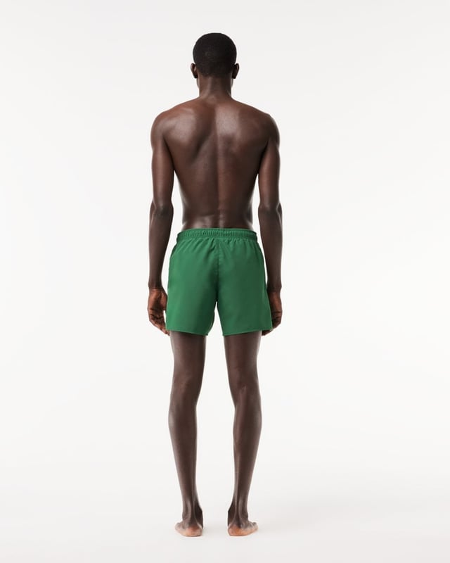 Step out of the water almost dry with these recycled quick-dry recycled polyester taffeta swim shorts. Loaded with practical features including two side pockets, mesh lining and a contrast drawstring. Your weekend getaway just got more exciting.
Light recycled quick-dry taffeta (smooth, very light weaved fabric with a slightly shiny finish)Side pocketsElasticised waistband with contrast drawstringMesh liningEmbroidered green crocodile on thighPolyester (100%)
MH6270