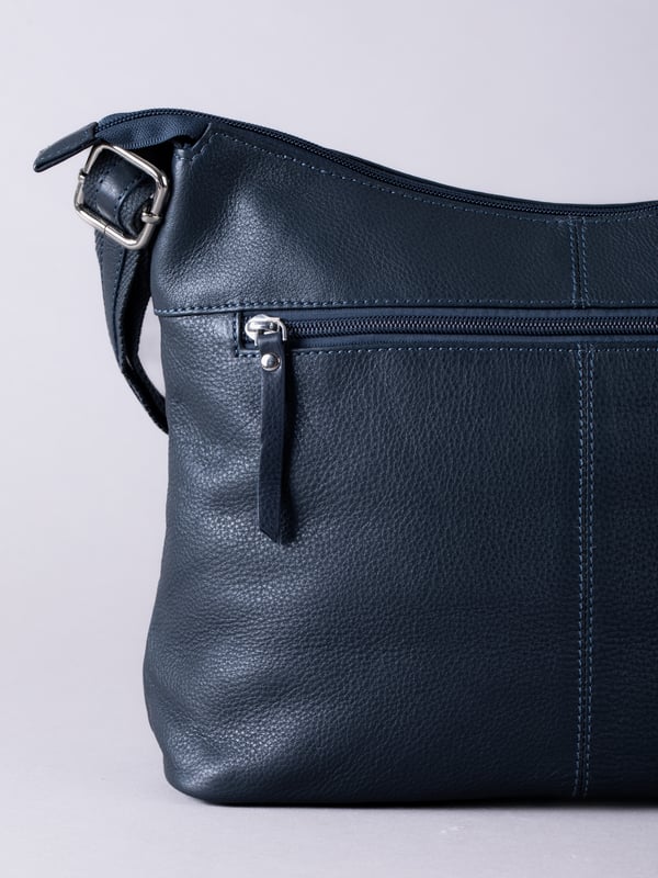 For sophisticated every day organisation, look no further than the Winleigh shoulder bag. Crafted from supple leather, this accessory wardrobe essential has a comfortable adjustable strap and pockets aplenty. In a classic navy colourway, this versatile bag will pair with all of your outfits no matter the season. Measurements: 36x24x14