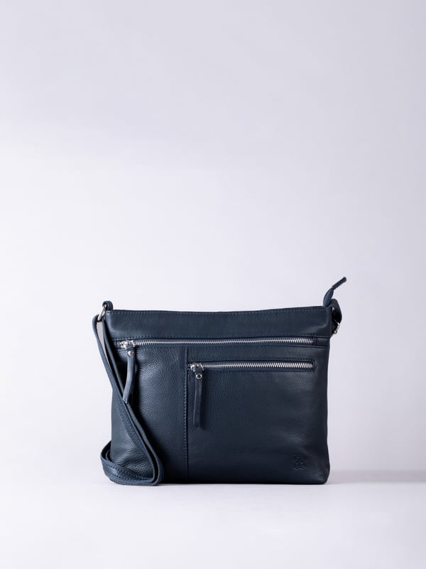 Expertly crafted from premium leather, the Winleigh cross body bag is as practical as it is stylish. Dual front zip pockets elevate this structured silhouette, whilst the adjustable cross body strap allows for versatile and comfortable wear. With plenty of room inside, this classic black bag is ideal for every day. Measurements: 28x24x8
