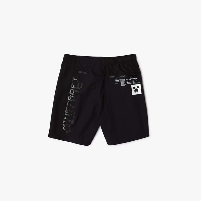 Unisex Lacoste x Minecraft Nylon Bermuda Shorts in Black Unisex Lacoste L!VE x Minecraft Nylon Bermuda Shorts.- Regular fit.- Responsible and water-resistant fabrics.- Four zip pockets, elasticised waistband with branded drawstring.- Matte and shiny Lacoste and Minecraft prints.- Tone-on-tone silicone crocodile on chest. Material: 100% Polyamide. Ref: FH5981031.