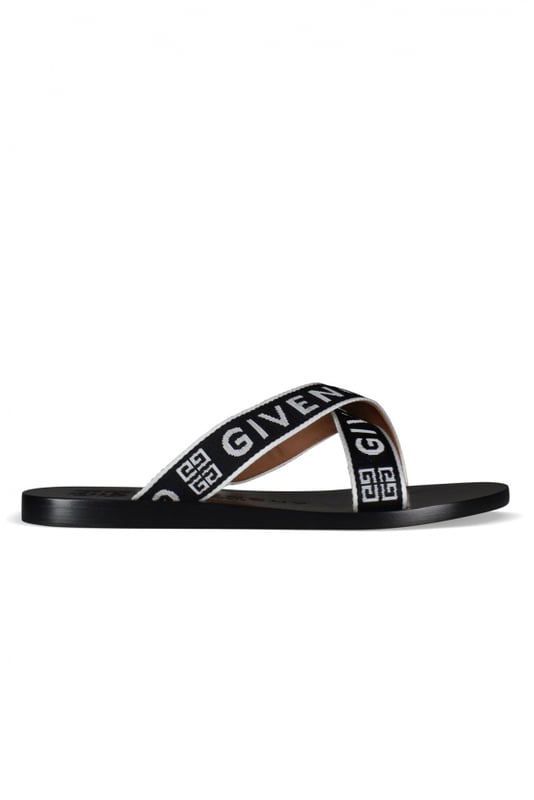 Sandalias de cuero negro Givenchy.Logotipo en la suela y las correas.Tacones bajos y planos con tiras de tela.Made in Italy.