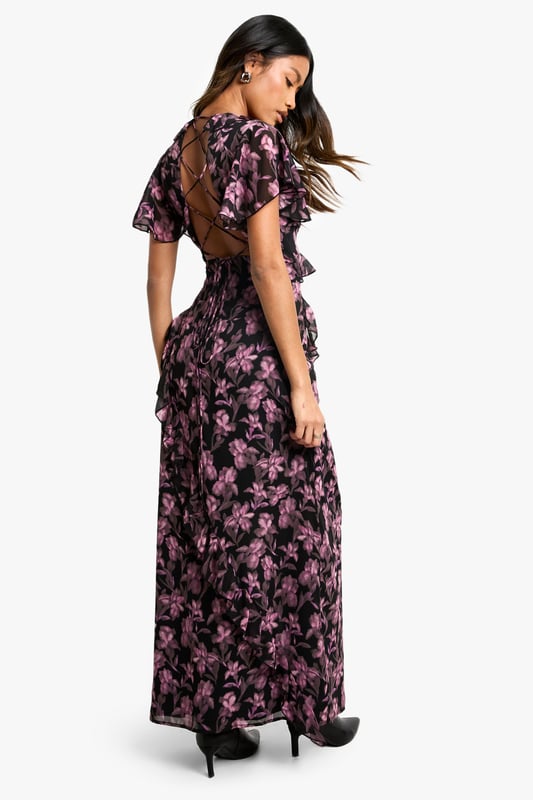 Alluring V-neckline for a feminine touch
        Flowy maxi length with a daring side slit
        Captivating floral print throughout
        Flattering wrap-style silhouette
        Short flutter sleeves for a romantic flair
    
    Make a lasting impression in this enchanting floral maxi dress, perfect for your next night out. The wrap-style silhouette gracefully hugs your curves, while the daring side slit adds a touch of allure to your ensemble. The V-neckline and short flutter sleeves create a romantic and feminine look that's sure to turn heads. Style this versatile piece with strappy heels and a clutch for a sophisticated cocktail party, or dress it down with ankle boots and a leather jacket for a chic dinner date. The maxi length offers elegance and drama, making it an ideal choice for various evening events. Whether you're dancing the night away or enjoying drinks with friends, this dress will keep you looking effortlessly stylish and ready for any urban adventure.
