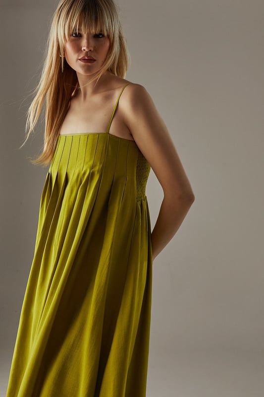 Strappy design with delicate shoulder straps
        Seam detail on bodice creating a pleated effect
        Bubble hem for a playful silhouette
        Midi length for versatile styling
        Relaxed fit through the body for effortless comfort
    
    This strappy seam detail bubble midi sundress from Warehouse is the epitome of casual chic. Perfect for those laid-back summer days, this dress combines comfort with style. The pleated bodice adds texture and interest, while the bubble hem creates a playful, feminine silhouette. Pair it with flat sandals and a woven tote for a relaxed daytime look, or dress it up with wedges and statement earrings for an alfresco dinner. The versatile midi length makes it suitable for various occasions, from family gatherings to casual brunches with friends. Layer with a denim jacket for cooler evenings or style with a wide-brimmed hat for a touch of glamour at outdoor events. This dress is a wardrobe essential that effortlessly transitions from day to night, embodying the confident and edgy spirit of the Warehouse brand.