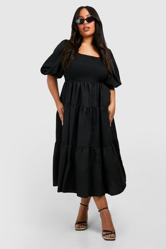 Tiered and ruched design for a flattering silhouette
        Square neckline adds a touch of elegance
        Voluminous puff sleeves create a dramatic look
        Midi length offers versatile styling options
        Smocked bodice ensures a comfortable fit
    
    Make a statement in this eye-catching tiered and ruched smock dress from Boohoo. Perfect for the fashion-forward woman who loves to embrace current trends, this dress combines comfort with style. The square neckline and puff sleeves add a touch of romance, while the tiered skirt creates movement and dimension. Ideal for casual events or family gatherings, this dress can be easily dressed up or down. Pair it with strappy sandals and statement earrings for a daytime look, or switch to heeled mules and a clutch bag for evening drinks. The midi length offers coverage whilst still allowing you to show off your favourite footwear. Whether you're heading to a garden party or a casual dinner date, this versatile dress will ensure you're always on-trend and feeling confident.