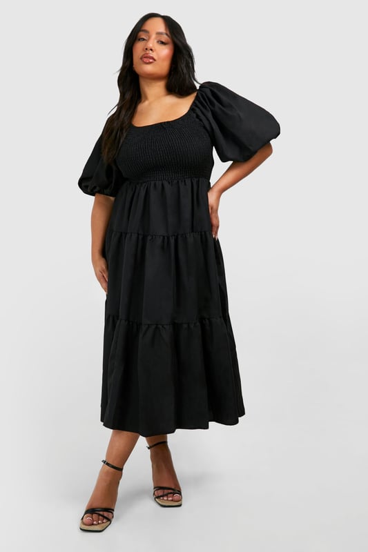 Tiered and ruched design for a flattering silhouette
        Square neckline adds a touch of elegance
        Voluminous puff sleeves create a dramatic look
        Midi length offers versatile styling options
        Smocked bodice ensures a comfortable fit
    
    Make a statement in this eye-catching tiered and ruched smock dress from Boohoo. Perfect for the fashion-forward woman who loves to embrace current trends, this dress combines comfort with style. The square neckline and puff sleeves add a touch of romance, while the tiered skirt creates movement and dimension. Ideal for casual events or family gatherings, this dress can be easily dressed up or down. Pair it with strappy sandals and statement earrings for a daytime look, or switch to heeled mules and a clutch bag for evening drinks. The midi length offers coverage whilst still allowing you to show off your favourite footwear. Whether you're heading to a garden party or a casual dinner date, this versatile dress will ensure you're always on-trend and feeling confident.