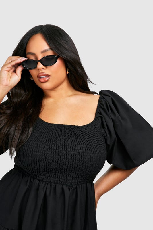Tiered and ruched design for a flattering silhouette
        Square neckline adds a touch of elegance
        Voluminous puff sleeves create a dramatic look
        Midi length offers versatile styling options
        Smocked bodice ensures a comfortable fit
    
    Make a statement in this eye-catching tiered and ruched smock dress from Boohoo. Perfect for the fashion-forward woman who loves to embrace current trends, this dress combines comfort with style. The square neckline and puff sleeves add a touch of romance, while the tiered skirt creates movement and dimension. Ideal for casual events or family gatherings, this dress can be easily dressed up or down. Pair it with strappy sandals and statement earrings for a daytime look, or switch to heeled mules and a clutch bag for evening drinks. The midi length offers coverage whilst still allowing you to show off your favourite footwear. Whether you're heading to a garden party or a casual dinner date, this versatile dress will ensure you're always on-trend and feeling confident.