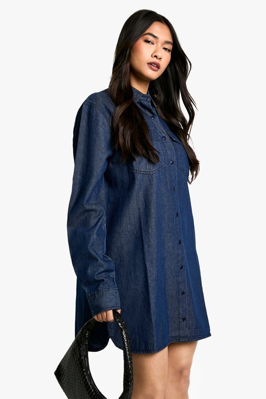 Oversized denim shirt dress for effortless style
        Classic collar and full-length button placket
        Roomy chest pockets for added functionality
        Long sleeves with buttoned cuffs for versatile wear
        Relaxed silhouette perfect for layering
    
    Embrace casual chic with this versatile oversized denim shirt dress from Boohoo. Its relaxed fit offers comfort without compromising on style, making it ideal for a range of casual occasions. Layer it over a fitted turtleneck and pair with opaque tights and ankle boots for a trendy autumn look. Alternatively, wear it unbuttoned over a crop top and cycling shorts for a laid-back summer ensemble. The classic denim fabric lends itself to easy accessorising - add a wide belt to cinch the waist or leave it loose for a more relaxed vibe. Perfect for family gatherings, weekend brunches, or casual outings with friends, this shirt dress is a wardrobe staple that can be dressed up or down to suit your mood and the occasion.