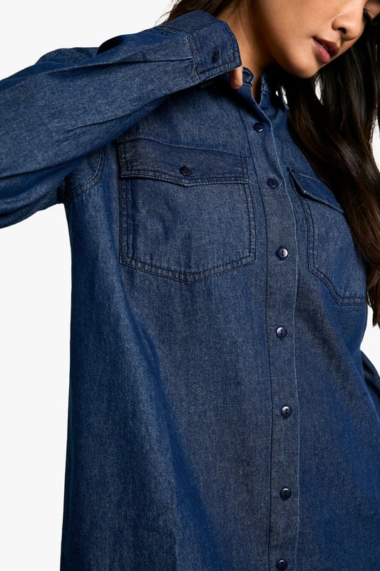 Oversized denim shirt dress for effortless style
        Classic collar and full-length button placket
        Roomy chest pockets for added functionality
        Long sleeves with buttoned cuffs for versatile wear
        Relaxed silhouette perfect for layering
    
    Embrace casual chic with this versatile oversized denim shirt dress from Boohoo. Its relaxed fit offers comfort without compromising on style, making it ideal for a range of casual occasions. Layer it over a fitted turtleneck and pair with opaque tights and ankle boots for a trendy autumn look. Alternatively, wear it unbuttoned over a crop top and cycling shorts for a laid-back summer ensemble. The classic denim fabric lends itself to easy accessorising - add a wide belt to cinch the waist or leave it loose for a more relaxed vibe. Perfect for family gatherings, weekend brunches, or casual outings with friends, this shirt dress is a wardrobe staple that can be dressed up or down to suit your mood and the occasion.