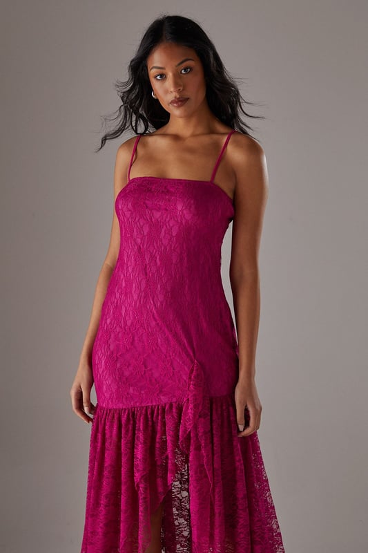 Delicate all-over lace fabric creates a romantic, feminine aesthetic
        Flattering drop waist silhouette with dramatic ruffle detail
        Elegant strappy neckline adds a contemporary touch
        Semi-sheer lace ruffle creates an asymmetric midi hemline
        Lined bodice ensures comfort and coverage where needed
    
    This striking Warehouse midi dress combines sophisticated design with bold femininity. The form-fitting bodice transitions into a playful drop waist ruffle, creating a silhouette that's both flattering and fashion-forward. The delicate lace fabric offers a beautiful textural contrast whilst the asymmetric hemline adds movement and drama. Style with strappy heels and a metallic clutch as shown for evening events, or dress down with leather mules and a tailored blazer for summer garden parties. Perfect for weddings, races or formal occasions where you want to make an impression, this versatile piece can be accessorised with statement jewellery for additional glamour or kept minimal to let the intricate lace detailing take centre stage. The strappy neckline frames the dcolletage beautifully, making this a confident choice for those special moments when you wish to command attention.