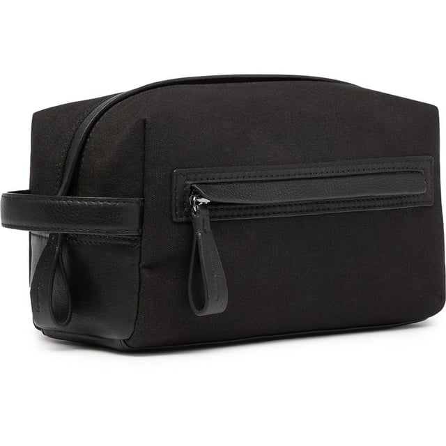 Travel in style with the Oliver Sweeney Hartwell washbag. This black leather toiletries bag makes a sharp statement whether on a short break or a weekend away. The water-resistant lining, elasticated internal pockets, zip closure and external zip pocket add to the practicality. This bag complements your make-up and shower essentials.