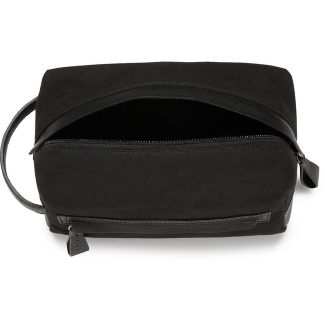 Travel in style with the Oliver Sweeney Hartwell washbag. This black leather toiletries bag makes a sharp statement whether on a short break or a weekend away. The water-resistant lining, elasticated internal pockets, zip closure and external zip pocket add to the practicality. This bag complements your make-up and shower essentials.