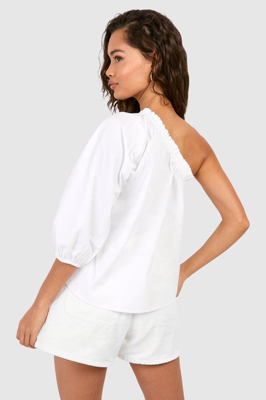 Striking one-shoulder design for a bold statement
        Voluminous puff sleeve adds dramatic flair
        Relaxed, breezy fit for effortless comfort
        Versatile woven cotton fabric for breathability
        Elastic neckline ensures a secure fit
    
    Make a stylish impact with this eye-catching one-shoulder top from Boohoo. The asymmetrical neckline creates an alluring silhouette, while the voluminous puff sleeve adds a touch of drama to your ensemble. Perfect for casual outings or family gatherings, this top effortlessly combines comfort with on-trend design. Style it with high-waisted shorts and sandals for a laid-back summer look, or dress it up with tailored trousers and statement earrings for an evening out. The lightweight cotton fabric ensures breathability, making it ideal for warm weather. Whether you're heading to a barbecue or meeting friends for brunch, this versatile piece will keep you looking chic and feeling cool. Its relaxed fit allows for easy movement, making it a go-to choice for various casual occasions.