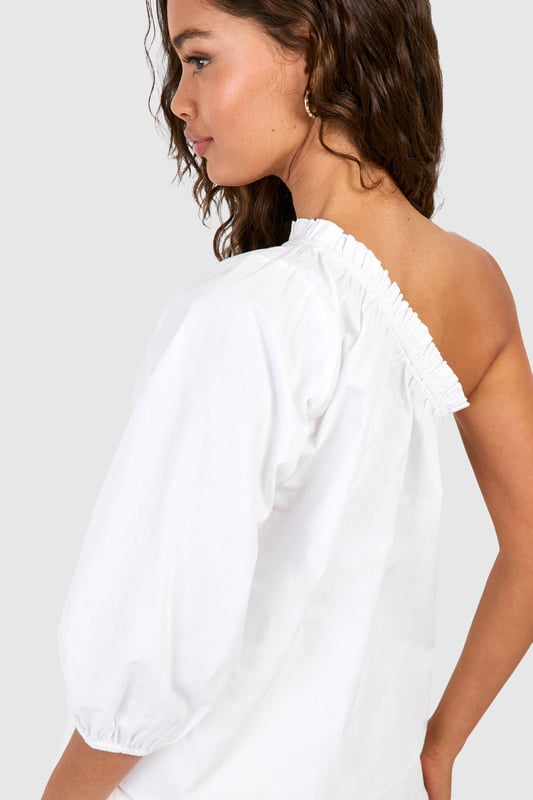 Striking one-shoulder design for a bold statement
        Voluminous puff sleeve adds dramatic flair
        Relaxed, breezy fit for effortless comfort
        Versatile woven cotton fabric for breathability
        Elastic neckline ensures a secure fit
    
    Make a stylish impact with this eye-catching one-shoulder top from Boohoo. The asymmetrical neckline creates an alluring silhouette, while the voluminous puff sleeve adds a touch of drama to your ensemble. Perfect for casual outings or family gatherings, this top effortlessly combines comfort with on-trend design. Style it with high-waisted shorts and sandals for a laid-back summer look, or dress it up with tailored trousers and statement earrings for an evening out. The lightweight cotton fabric ensures breathability, making it ideal for warm weather. Whether you're heading to a barbecue or meeting friends for brunch, this versatile piece will keep you looking chic and feeling cool. Its relaxed fit allows for easy movement, making it a go-to choice for various casual occasions.