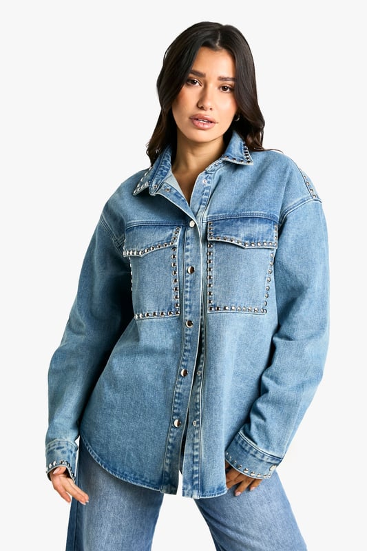 Oversized fit for a relaxed, on-trend silhouette
        Studded detailing adds an edgy, rock-inspired touch
        Chest pockets with stud-trimmed flaps for added style and functionality
        Long sleeves with buttoned cuffs for versatile wear
        Classic collar and button-down front for a timeless denim look
    
    Make a bold statement with this Tall Oversize Jeanshemd, perfect for the fashion-forward woman who loves to stand out. The oversized fit offers a contemporary twist on the classic denim shirt, while the eye-catching studded details add a touch of rock-chic glamour. Style this versatile piece for a range of casual occasions - pair it with wide-leg jeans and trainers for a cool, double-denim look, or throw it over a simple dress for an effortlessly stylish ensemble. For a more laid-back vibe, leave it unbuttoned over a crop top and high-waisted trousers. The shirt's adaptable nature makes it ideal for family gatherings, brunches with friends, or casual nights out. Its durable denim fabric ensures comfort and longevity, making it a wardrobe staple that you'll reach for time and time again. Embrace the oversized trend and let this studded denim shirt become your go-to piece for effortless, eye-catching style.