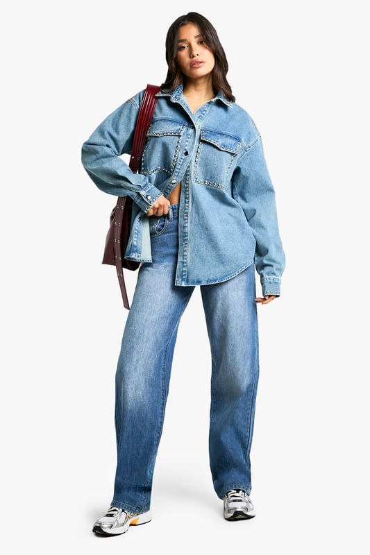 Oversized fit for a relaxed, on-trend silhouette
        Studded detailing adds an edgy, rock-inspired touch
        Chest pockets with stud-trimmed flaps for added style and functionality
        Long sleeves with buttoned cuffs for versatile wear
        Classic collar and button-down front for a timeless denim look
    
    Make a bold statement with this Tall Oversize Jeanshemd, perfect for the fashion-forward woman who loves to stand out. The oversized fit offers a contemporary twist on the classic denim shirt, while the eye-catching studded details add a touch of rock-chic glamour. Style this versatile piece for a range of casual occasions - pair it with wide-leg jeans and trainers for a cool, double-denim look, or throw it over a simple dress for an effortlessly stylish ensemble. For a more laid-back vibe, leave it unbuttoned over a crop top and high-waisted trousers. The shirt's adaptable nature makes it ideal for family gatherings, brunches with friends, or casual nights out. Its durable denim fabric ensures comfort and longevity, making it a wardrobe staple that you'll reach for time and time again. Embrace the oversized trend and let this studded denim shirt become your go-to piece for effortless, eye-catching style.