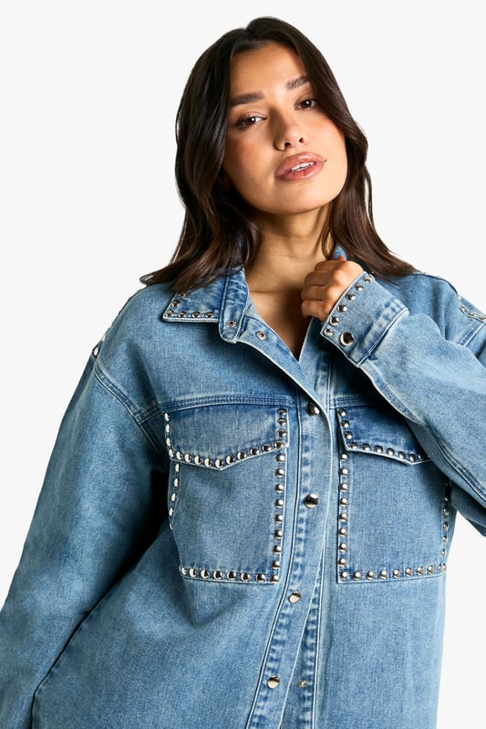 Oversized fit for a relaxed, on-trend silhouette
        Studded detailing adds an edgy, rock-inspired touch
        Chest pockets with stud-trimmed flaps for added style and functionality
        Long sleeves with buttoned cuffs for versatile wear
        Classic collar and button-down front for a timeless denim look
    
    Make a bold statement with this Tall Oversize Jeanshemd, perfect for the fashion-forward woman who loves to stand out. The oversized fit offers a contemporary twist on the classic denim shirt, while the eye-catching studded details add a touch of rock-chic glamour. Style this versatile piece for a range of casual occasions - pair it with wide-leg jeans and trainers for a cool, double-denim look, or throw it over a simple dress for an effortlessly stylish ensemble. For a more laid-back vibe, leave it unbuttoned over a crop top and high-waisted trousers. The shirt's adaptable nature makes it ideal for family gatherings, brunches with friends, or casual nights out. Its durable denim fabric ensures comfort and longevity, making it a wardrobe staple that you'll reach for time and time again. Embrace the oversized trend and let this studded denim shirt become your go-to piece for effortless, eye-catching style.