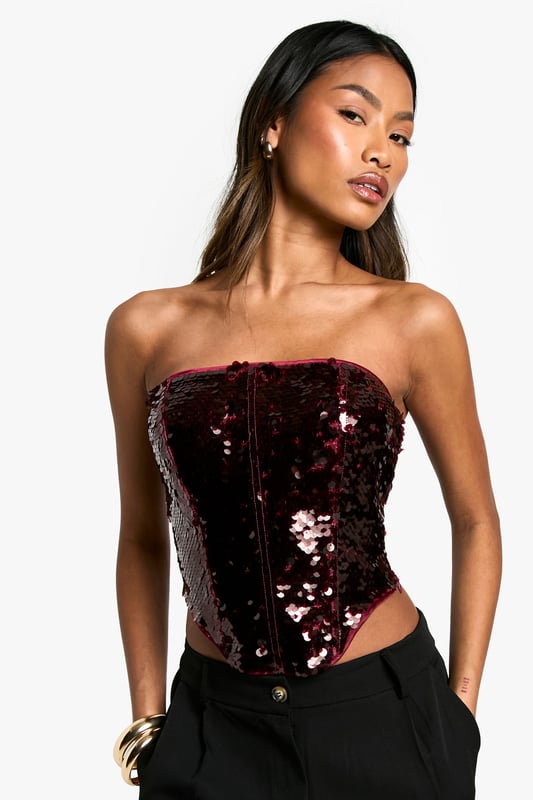 Strapless corset-style top with all-over sequin embellishment
        Lace-up back detail for adjustable fit
        Structured boning for shape and support
        Straight neckline for a classic look
        Cropped length perfect for pairing with high-waisted bottoms
    
    Make a dazzling entrance at your next festive celebration with this show-stopping sequin corset top. The strapless design and structured boning create a flattering silhouette, while the lace-up back allows for a customised fit. Style this eye-catching piece with sleek wide-leg trousers and stiletto heels for a glamorous Christmas party ensemble. For a more relaxed yet equally chic look, pair it with high-waisted jeans and strappy sandals. The versatile nature of this top makes it suitable for various occasions beyond the holiday season, from cocktail parties to nights out on the town. Accessorise with statement earrings and a clutch bag to complete your head-turning outfit.