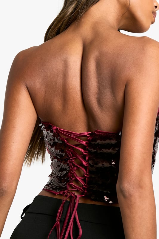 Strapless corset-style top with all-over sequin embellishment
        Lace-up back detail for adjustable fit
        Structured boning for shape and support
        Straight neckline for a classic look
        Cropped length perfect for pairing with high-waisted bottoms
    
    Make a dazzling entrance at your next festive celebration with this show-stopping sequin corset top. The strapless design and structured boning create a flattering silhouette, while the lace-up back allows for a customised fit. Style this eye-catching piece with sleek wide-leg trousers and stiletto heels for a glamorous Christmas party ensemble. For a more relaxed yet equally chic look, pair it with high-waisted jeans and strappy sandals. The versatile nature of this top makes it suitable for various occasions beyond the holiday season, from cocktail parties to nights out on the town. Accessorise with statement earrings and a clutch bag to complete your head-turning outfit.
