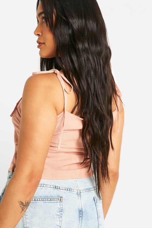 Ruched detailing for a flattering silhouette
        Adjustable tie straps for a customised fit
        Square neckline adds a modern touch
        Cropped length perfect for high-waisted bottoms
        Linen-look fabric for a breezy, summery feel
    
    Embrace effortless style with this versatile plus-size top from Boohoo. The ruched detailing and square neckline create a figure-flattering look, while the adjustable tie straps allow for a personalised fit. Perfect for casual outings, this top pairs beautifully with high-waisted jeans or a flowing maxi skirt. The linen-look fabric offers a lightweight, breathable option for warm days, making it ideal for family gatherings or leisurely brunches with friends. Style it with wide-leg trousers and sandals for a chic daytime ensemble, or dress it up with a statement necklace and wedges for evening drinks. This adaptable piece is sure to become a staple in your summer wardrobe, offering both comfort and style for various casual occasions.