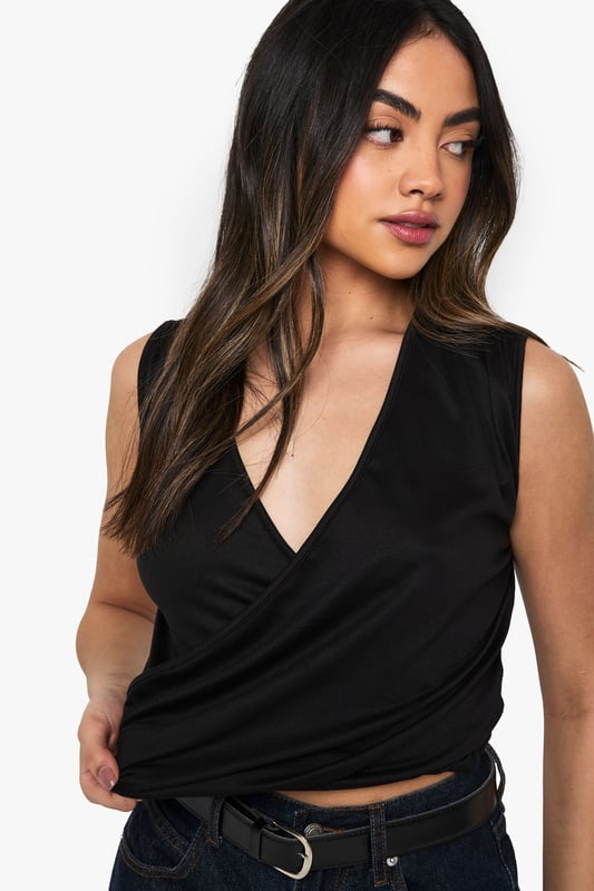 Sleeveless wrap design with elegant draping detail
        Flattering V-neckline that enhances your dcolletage
        Soft jersey fabric with gentle stretch for comfortable movement
        Versatile silhouette that can be tucked in or worn loose
        Figure-enhancing fit that contours to your shape
    
    This draped jersey wrap top is the ultimate day-to-night essential for your wardrobe. The sophisticated wrap design creates beautiful draping that flatters every figure, whilst the deep V-neckline adds a touch of allure perfect for evening occasions. Style it as seen with wide-leg denim trousers and a belt for a contemporary contrast, or pair with a sleek pencil skirt for a more polished look. For nights out, team with your favourite high-waisted jeans, statement earrings and a clutch bag for effortless glamour. The versatile nature of this Boohoo top makes it ideal for spontaneous drinks after work-simply switch your daytime accessories for something more dramatic and you're ready to turn heads at the bar.