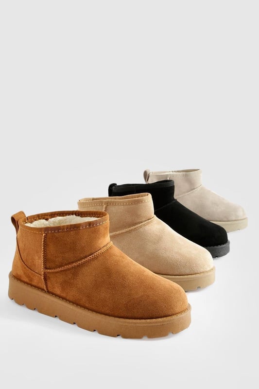 Ultra mini design for a trendy, compact silhouette
        Cosy synthetic suede upper for warmth and comfort
        Slip-on style for easy wear
        Durable synthetic outer sole for traction
        Versatile ankle height suitable for various outfits
    
    Step into comfort and style with these ultra mini cosy boots from Boohoo. Perfect for the fashion-forward woman who values both trend and practicality, these boots offer a snug fit that's ideal for chilly days. The ankle-height design makes them incredibly versatile, pairing effortlessly with everything from skinny jeans to midi skirts. For a laid-back look, team them with oversized knitwear and leggings, or dress them up with a flowy dress and tights for casual outings. These boots are a must-have for family gatherings, coffee dates, or weekend shopping trips. Their compact size makes them an excellent choice for travel, easily fitting into your luggage without sacrificing style. Embrace the cosy-chic trend and make these ultra mini boots your go-to footwear for comfortable, on-trend casual wear.