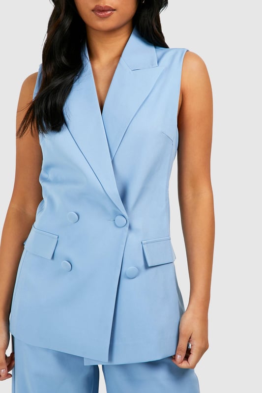Sleeveless design for a modern, chic look
        Double-breasted front with button closure
        Notched lapels for a classic blazer silhouette
        Functional front pockets for added practicality
        Tailored fit to flatter the petite frame
    
    Make a bold statement with this sleeveless blazer, perfect for the fashion-forward woman who loves to stand out. The tailored fit accentuates your silhouette, while the sleeveless design adds a contemporary twist to the classic blazer. Pair it with the matching wide-leg trousers for a coordinated power suit look that's ideal for a night out on the town. For a more casual ensemble, throw it over a crop top and high-waisted jeans. Accessorise with statement earrings and a clutch bag to complete your look. Whether you're heading to a trendy bar or meeting friends for drinks, this versatile piece will ensure you're dressed to impress. The double-breasted front and notched lapels add a touch of sophistication, making it suitable for both casual and semi-formal occasions. Embrace your confidence and let this blazer be the centrepiece of your going-out wardrobe.