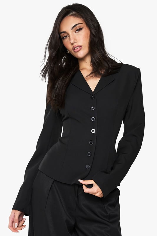 Striking button detail running down the front creates a sophisticated focal point
        Fitted silhouette with cinched waist accentuates your natural curves
        Structured shoulders and lapel collar offer a polished, tailored appearance
        Long sleeves with subtle cuff detail provide a refined finishing touch
        Versatile regular fit allows for comfortable movement whilst maintaining shape
    
    Make a statement with this Button Detail Fitted Cinched Blazer from Boohoo. The expertly tailored silhouette creates a flattering hourglass shape that commands attention, whilst the classic button-up design adds timeless appeal. Perfect for evening occasions, pair with wide-leg trousers as shown for a contemporary power suit that transitions effortlessly from office to nightlife. For a night out, style with a lace camisole underneath, statement jewellery and heels for a look that radiates confidence. The structured design and cinched waist detail make this blazer an essential wardrobe piece that works beautifully for drinks with friends or club nights when you want to combine sophistication with urban edge. The slight stretch in the fabric ensures comfort doesn't compromise on style, allowing you to dance the night away.