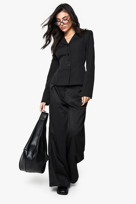 Striking button detail running down the front creates a sophisticated focal point
        Fitted silhouette with cinched waist accentuates your natural curves
        Structured shoulders and lapel collar offer a polished, tailored appearance
        Long sleeves with subtle cuff detail provide a refined finishing touch
        Versatile regular fit allows for comfortable movement whilst maintaining shape
    
    Make a statement with this Button Detail Fitted Cinched Blazer from Boohoo. The expertly tailored silhouette creates a flattering hourglass shape that commands attention, whilst the classic button-up design adds timeless appeal. Perfect for evening occasions, pair with wide-leg trousers as shown for a contemporary power suit that transitions effortlessly from office to nightlife. For a night out, style with a lace camisole underneath, statement jewellery and heels for a look that radiates confidence. The structured design and cinched waist detail make this blazer an essential wardrobe piece that works beautifully for drinks with friends or club nights when you want to combine sophistication with urban edge. The slight stretch in the fabric ensures comfort doesn't compromise on style, allowing you to dance the night away.