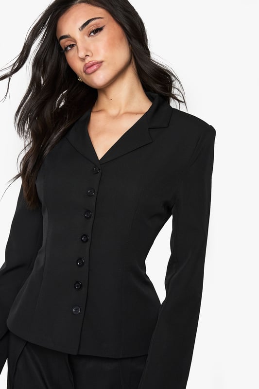 Striking button detail running down the front creates a sophisticated focal point
        Fitted silhouette with cinched waist accentuates your natural curves
        Structured shoulders and lapel collar offer a polished, tailored appearance
        Long sleeves with subtle cuff detail provide a refined finishing touch
        Versatile regular fit allows for comfortable movement whilst maintaining shape
    
    Make a statement with this Button Detail Fitted Cinched Blazer from Boohoo. The expertly tailored silhouette creates a flattering hourglass shape that commands attention, whilst the classic button-up design adds timeless appeal. Perfect for evening occasions, pair with wide-leg trousers as shown for a contemporary power suit that transitions effortlessly from office to nightlife. For a night out, style with a lace camisole underneath, statement jewellery and heels for a look that radiates confidence. The structured design and cinched waist detail make this blazer an essential wardrobe piece that works beautifully for drinks with friends or club nights when you want to combine sophistication with urban edge. The slight stretch in the fabric ensures comfort doesn't compromise on style, allowing you to dance the night away.
