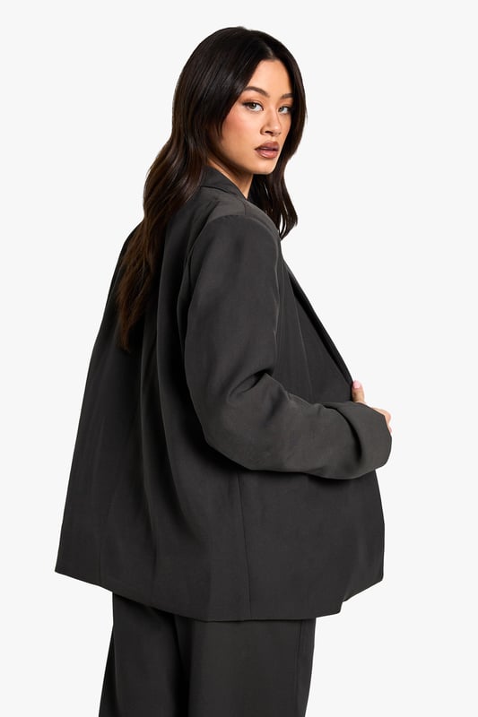 Oversized fit for a relaxed, contemporary silhouette
        Versatile blazer-dress design for multiple styling options
        Notched lapels and single-button closure for a classic touch
        Flap pockets add functional detail to the design
        Tall fit ensures proper length for taller frames
    
    Make a bold statement with this Tall Oversize Blazer-Dress from Boohoo. Perfect for the fashion-forward woman who loves to experiment with her style, this piece offers endless versatility. Wear it as a dress for a daring look that's sure to turn heads, or style it open over wide-leg trousers for a chic, modern ensemble. The oversized fit allows for layering, making it ideal for transitional weather. Pair with trainers and a baseball cap for a casual daytime look, or dress it up with heeled boots and statement jewellery for an evening out with friends. The tall fit ensures the perfect length, allowing you to style it confidently whether you're heading to a family gathering or a casual lunch date. This blazer-dress is a must-have addition to any wardrobe, offering both comfort and style for the trendsetting Boohoo girl.