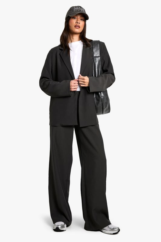 Oversized fit for a relaxed, contemporary silhouette
        Versatile blazer-dress design for multiple styling options
        Notched lapels and single-button closure for a classic touch
        Flap pockets add functional detail to the design
        Tall fit ensures proper length for taller frames
    
    Make a bold statement with this Tall Oversize Blazer-Dress from Boohoo. Perfect for the fashion-forward woman who loves to experiment with her style, this piece offers endless versatility. Wear it as a dress for a daring look that's sure to turn heads, or style it open over wide-leg trousers for a chic, modern ensemble. The oversized fit allows for layering, making it ideal for transitional weather. Pair with trainers and a baseball cap for a casual daytime look, or dress it up with heeled boots and statement jewellery for an evening out with friends. The tall fit ensures the perfect length, allowing you to style it confidently whether you're heading to a family gathering or a casual lunch date. This blazer-dress is a must-have addition to any wardrobe, offering both comfort and style for the trendsetting Boohoo girl.