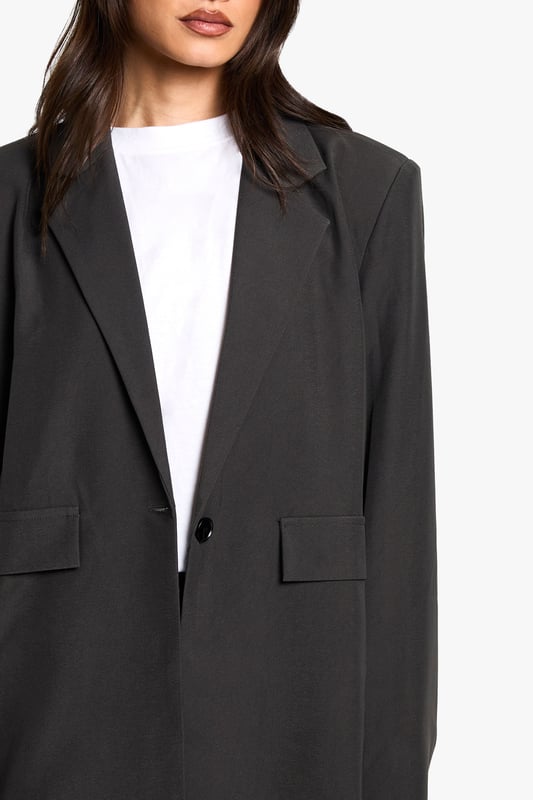 Oversized fit for a relaxed, contemporary silhouette
        Versatile blazer-dress design for multiple styling options
        Notched lapels and single-button closure for a classic touch
        Flap pockets add functional detail to the design
        Tall fit ensures proper length for taller frames
    
    Make a bold statement with this Tall Oversize Blazer-Dress from Boohoo. Perfect for the fashion-forward woman who loves to experiment with her style, this piece offers endless versatility. Wear it as a dress for a daring look that's sure to turn heads, or style it open over wide-leg trousers for a chic, modern ensemble. The oversized fit allows for layering, making it ideal for transitional weather. Pair with trainers and a baseball cap for a casual daytime look, or dress it up with heeled boots and statement jewellery for an evening out with friends. The tall fit ensures the perfect length, allowing you to style it confidently whether you're heading to a family gathering or a casual lunch date. This blazer-dress is a must-have addition to any wardrobe, offering both comfort and style for the trendsetting Boohoo girl.
