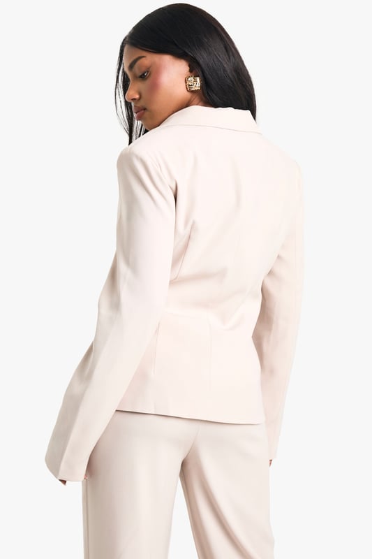 Slim fit blazer with hook and eye closure for a sleek silhouette
        Corset-inspired detailing adds a contemporary twist
        Collared neckline for a classic touch
        Woven crepe fabric offers a structured yet comfortable feel
        Versatile design suitable for various going-out occasions
    
    Make a statement in this chic blazer that seamlessly blends timeless elegance with modern flair. The slim fit design sculpts your figure, while the corset-inspired detailing adds an edgy, fashion-forward element. Perfect for a night out on the town, this blazer can be styled to suit a variety of evening events. Pair it with matching wide-leg trousers and strappy heels for a sophisticated club ensemble, or throw it over a bodycon dress for drinks at an upscale bar. The versatile nature of this piece allows for endless styling possibilities - dress it down with jeans and trainers for a casual meet-up with friends, or glam it up with statement jewellery and a clutch bag for a more formal night out. Whatever the occasion, this blazer is sure to turn heads and keep you looking effortlessly stylish throughout your urban adventures.
