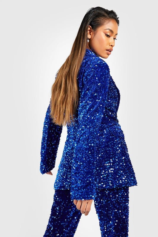 Dazzling all-over sequin embellishment
        Plunging neckline for a bold statement
        Structured shoulders and tailored fit
        Long sleeves with padded shoulders
        Versatile piece for festive occasions
    
    Make a grand entrance at your next Christmas soire with this show-stopping velvet sequin blazer. The plunging neckline adds a daring touch, while the all-over sequin embellishment ensures you'll sparkle from every angle. Perfect for those who love to stand out, this blazer can be styled multiple ways for various festive celebrations. Pair it with matching sequin trousers for a head-to-toe glam look, or throw it over a little black dress for instant glamour. The structured shoulders and tailored fit create a flattering silhouette, making it ideal for Christmas parties or New Year's Eve bashes. Accessorise with statement earrings and sky-high heels to complete your party-ready ensemble. This versatile piece will become your go-to for adding a touch of sparkle to any festive outfit.