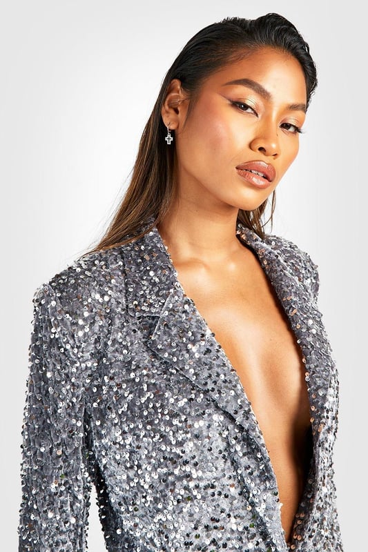 Dazzling all-over sequin embellishment
        Plunging neckline for a bold statement
        Structured shoulders and tailored fit
        Long sleeves with padded shoulders
        Versatile piece for festive occasions
    
    Make a grand entrance at your next Christmas soire with this show-stopping velvet sequin blazer. The plunging neckline adds a daring touch, while the all-over sequin embellishment ensures you'll sparkle from every angle. Perfect for those who love to stand out, this blazer can be styled multiple ways for various festive celebrations. Pair it with matching sequin trousers for a head-to-toe glam look, or throw it over a little black dress for instant glamour. The structured shoulders and tailored fit create a flattering silhouette, making it ideal for Christmas parties or New Year's Eve bashes. Accessorise with statement earrings and sky-high heels to complete your party-ready ensemble. This versatile piece will become your go-to for adding a touch of sparkle to any festive outfit.