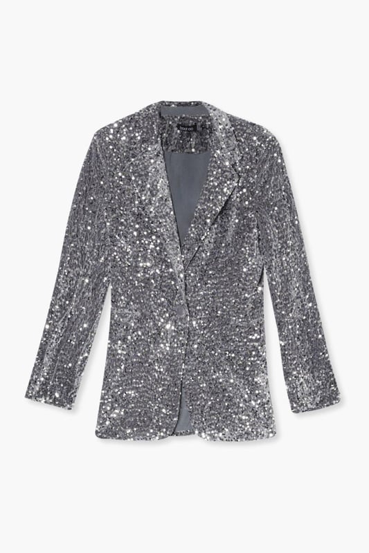 Dazzling all-over sequin embellishment
        Plunging neckline for a bold statement
        Structured shoulders and tailored fit
        Long sleeves with padded shoulders
        Versatile piece for festive occasions
    
    Make a grand entrance at your next Christmas soire with this show-stopping velvet sequin blazer. The plunging neckline adds a daring touch, while the all-over sequin embellishment ensures you'll sparkle from every angle. Perfect for those who love to stand out, this blazer can be styled multiple ways for various festive celebrations. Pair it with matching sequin trousers for a head-to-toe glam look, or throw it over a little black dress for instant glamour. The structured shoulders and tailored fit create a flattering silhouette, making it ideal for Christmas parties or New Year's Eve bashes. Accessorise with statement earrings and sky-high heels to complete your party-ready ensemble. This versatile piece will become your go-to for adding a touch of sparkle to any festive outfit.