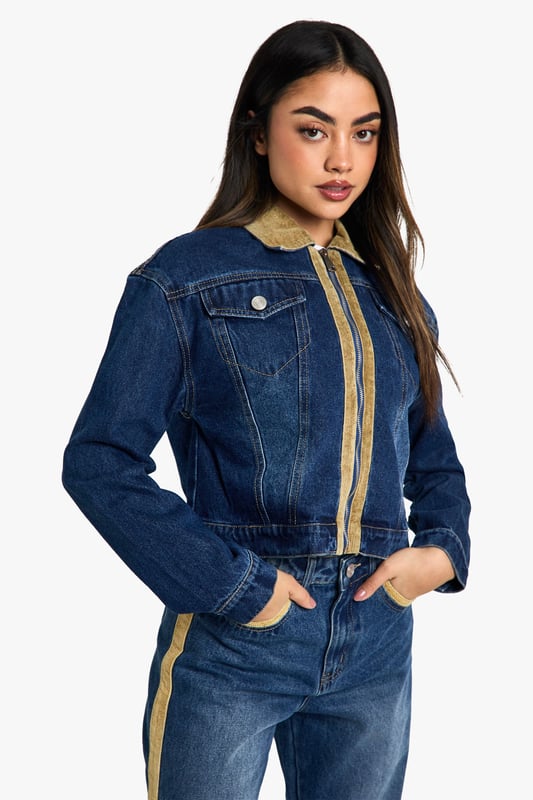 Distinctive corduroy collar and trim detailing
        Classic button-up front closure
        Functional chest pocket for added utility
        Cropped length for a modern silhouette
        Versatile denim construction for year-round wear
    
    Embrace the fusion of classic and contemporary with this eye-catching jeans jacket from Boohoo. The corduroy collar and trim inject a touch of retro charm, whilst the cropped silhouette keeps the look firmly on-trend. Perfect for layering, this jacket is a versatile piece that can be styled for various casual occasions. Pair it with high-waisted jeans and a simple white tee for a laid-back weekend look, or throw it over a floral dress and trainers for a fun family gathering. The functional chest pocket adds a practical element to the design, ideal for keeping small essentials close at hand. Whether you're heading to a casual lunch with friends or a relaxed evening out, this jacket will add an effortless cool to your ensemble. Its adaptable nature makes it a wardrobe staple that can transition seamlessly from day to night, ensuring you're always ready for wherever your social calendar takes you.