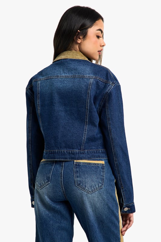 Distinctive corduroy collar and trim detailing
        Classic button-up front closure
        Functional chest pocket for added utility
        Cropped length for a modern silhouette
        Versatile denim construction for year-round wear
    
    Embrace the fusion of classic and contemporary with this eye-catching jeans jacket from Boohoo. The corduroy collar and trim inject a touch of retro charm, whilst the cropped silhouette keeps the look firmly on-trend. Perfect for layering, this jacket is a versatile piece that can be styled for various casual occasions. Pair it with high-waisted jeans and a simple white tee for a laid-back weekend look, or throw it over a floral dress and trainers for a fun family gathering. The functional chest pocket adds a practical element to the design, ideal for keeping small essentials close at hand. Whether you're heading to a casual lunch with friends or a relaxed evening out, this jacket will add an effortless cool to your ensemble. Its adaptable nature makes it a wardrobe staple that can transition seamlessly from day to night, ensuring you're always ready for wherever your social calendar takes you.