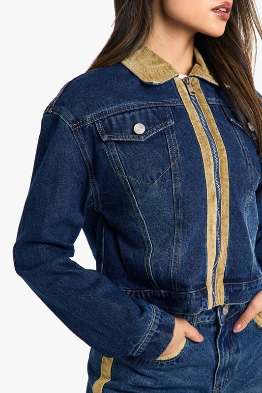 Distinctive corduroy collar and trim detailing
        Classic button-up front closure
        Functional chest pocket for added utility
        Cropped length for a modern silhouette
        Versatile denim construction for year-round wear
    
    Embrace the fusion of classic and contemporary with this eye-catching jeans jacket from Boohoo. The corduroy collar and trim inject a touch of retro charm, whilst the cropped silhouette keeps the look firmly on-trend. Perfect for layering, this jacket is a versatile piece that can be styled for various casual occasions. Pair it with high-waisted jeans and a simple white tee for a laid-back weekend look, or throw it over a floral dress and trainers for a fun family gathering. The functional chest pocket adds a practical element to the design, ideal for keeping small essentials close at hand. Whether you're heading to a casual lunch with friends or a relaxed evening out, this jacket will add an effortless cool to your ensemble. Its adaptable nature makes it a wardrobe staple that can transition seamlessly from day to night, ensuring you're always ready for wherever your social calendar takes you.