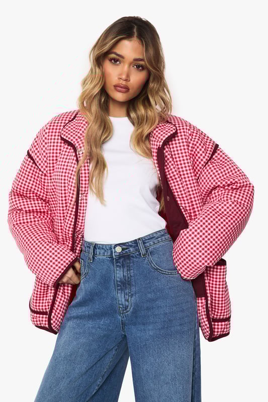 Oversized jacket featuring eye-catching gingham print with contrasting trim detailing
        Roomy front pockets with decorative piping for both style and functionality
        Relaxed drop-shoulder design offering a contemporary silhouette
        Button-through front closure for easy wear and versatility
        High collar that can be worn up or down depending on your style preference
    
    Make a bold statement with this striking oversized jacket that combines retro charm with modern styling. The distinctive gingham pattern creates visual interest while the generous cut ensures comfort for everyday wear. Style it as seen with wide-leg jeans and a simple white tee for an effortlessly cool daytime look, or layer over a fitted dress for a playful contrast in proportions. Perfect for casual outings, weekend brunches or family gatherings, this jacket works brilliantly with trainers for a relaxed vibe. For cooler days, add a beanie and chunky scarf to complete the look. The versatile design transitions seamlessly from autumn strolls to spring picnics, making it a wardrobe staple that will refresh your casual collection with its distinctive character and relaxed appeal.