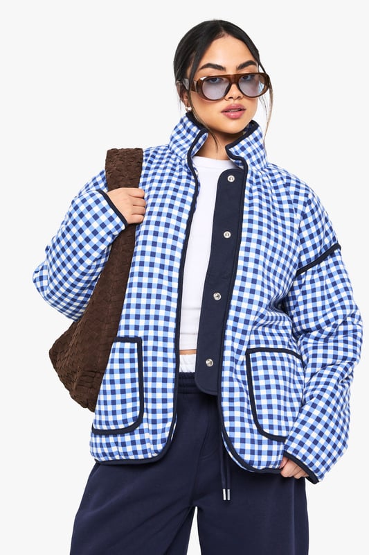 Oversized fit for a relaxed and trendy silhouette
        Eye-catching gingham print throughout
        High collar for added warmth and style
        Functional front pockets for convenience
        Versatile design suitable for layering
    
    Make a bold statement with this striking oversized jacket from Boohoo. The all-over gingham print adds a playful touch to your casual wardrobe, perfect for those who love to stay on-trend. The roomy fit allows for easy layering over your favourite jumpers or hoodies when the temperature drops. Style it with wide-leg trousers and trainers for a contemporary street-style look, or throw it over a simple dress and ankle boots for a chic daytime ensemble. Ideal for casual outings, from coffee dates to shopping trips, this jacket is a versatile piece that will quickly become a go-to in your wardrobe. Its blend of comfort and style makes it a must-have for the fashion-forward woman who values both practicality and flair in her everyday attire.