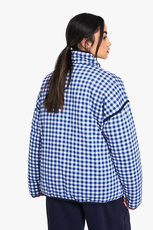 Oversized fit for a relaxed and trendy silhouette
        Eye-catching gingham print throughout
        High collar for added warmth and style
        Functional front pockets for convenience
        Versatile design suitable for layering
    
    Make a bold statement with this striking oversized jacket from Boohoo. The all-over gingham print adds a playful touch to your casual wardrobe, perfect for those who love to stay on-trend. The roomy fit allows for easy layering over your favourite jumpers or hoodies when the temperature drops. Style it with wide-leg trousers and trainers for a contemporary street-style look, or throw it over a simple dress and ankle boots for a chic daytime ensemble. Ideal for casual outings, from coffee dates to shopping trips, this jacket is a versatile piece that will quickly become a go-to in your wardrobe. Its blend of comfort and style makes it a must-have for the fashion-forward woman who values both practicality and flair in her everyday attire.