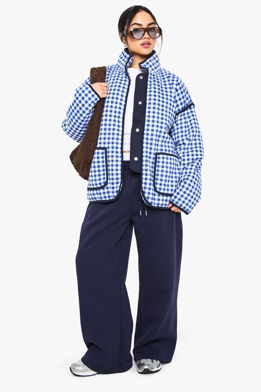 Oversized fit for a relaxed and trendy silhouette
        Eye-catching gingham print throughout
        High collar for added warmth and style
        Functional front pockets for convenience
        Versatile design suitable for layering
    
    Make a bold statement with this striking oversized jacket from Boohoo. The all-over gingham print adds a playful touch to your casual wardrobe, perfect for those who love to stay on-trend. The roomy fit allows for easy layering over your favourite jumpers or hoodies when the temperature drops. Style it with wide-leg trousers and trainers for a contemporary street-style look, or throw it over a simple dress and ankle boots for a chic daytime ensemble. Ideal for casual outings, from coffee dates to shopping trips, this jacket is a versatile piece that will quickly become a go-to in your wardrobe. Its blend of comfort and style makes it a must-have for the fashion-forward woman who values both practicality and flair in her everyday attire.